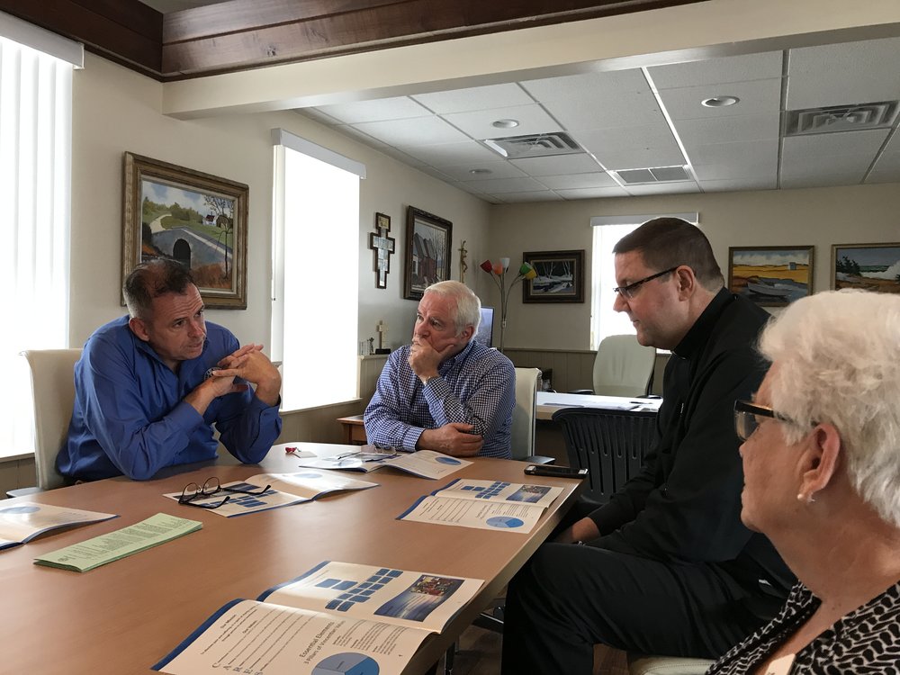  Pictured with Bishop Parkes is our CEO Michael J. Raposa, Board Presidnt Patrick Sullivan and COO Sheila Lopez. 